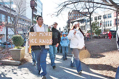 José Castillo (left) and community members march in downtown Asheville against ICE policies. Photo: COLA