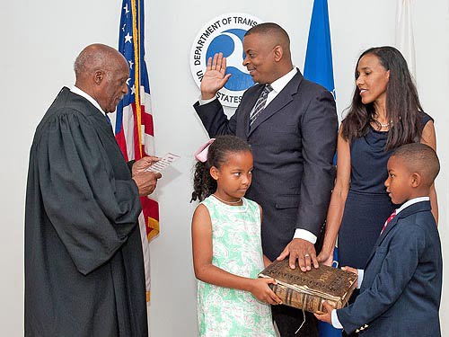 Judge Nathaniel Jones (left), swears in Anthony Foxx (center), while Foxx’s wife, Samara, and children,  Hillary and Zachary, hold the family’s heirloom Bible.  Photo: White House