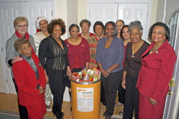 MANNA Food Bank Executive Director Cindy Threlkeld (far left) with the Asheville Chapter of the Links during MANNA’s holiday fundraising event.  Photo: Urban News