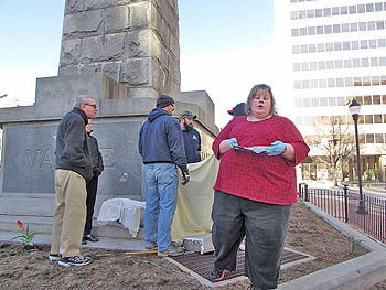 Heather South along with city of Asheville workers and officials unearth the time capsule from the Vance Monument. 