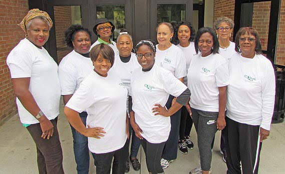 Members of the Asheville Chapter of the Links pause for a moment before the walk to show off their health walk t-shirts. Photo: Urban News
