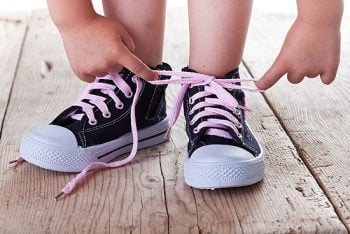 child tying shoes