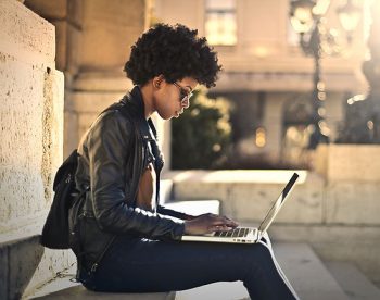 student on laptop outdoors