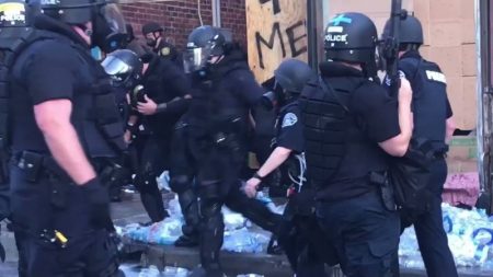 Police violently destroy bottles of water.