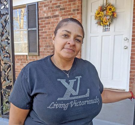 Tracie Covington of Forest City, in front of her new rental home.