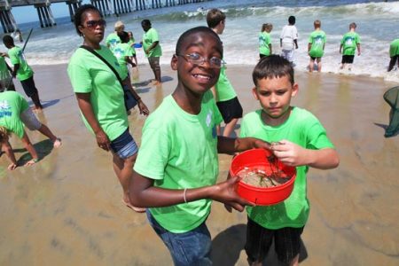 Young students learn through a hands-on beach experience.