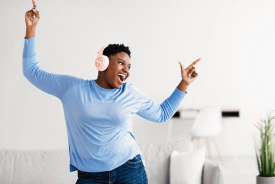 woman dancing with headphones on