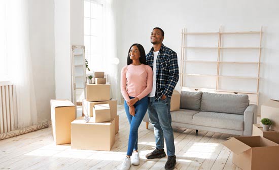 Happy black couple in house on moving day