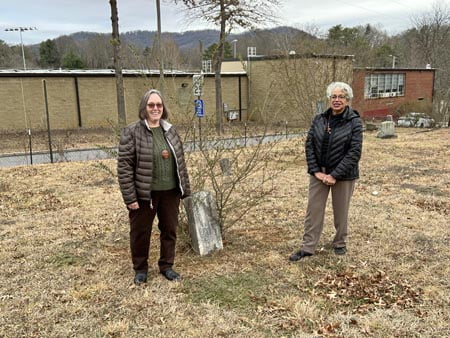Diane Zimmeran (L) and Anita White-Carter stand in the 134-year-old Shiloh A.M.E. Church cemetery.