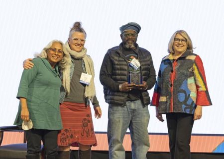(L-R): Ameena Batada, UNC Asheville health and wellness faculty; Safi Martin, chief operating officer, Hood Huggers International; DeWayne Barton, founder/CEO, Hood Huggers International; Kimberly van Noort, interim chancellor of UNC Asheville.