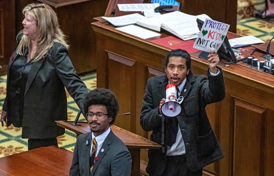 Reps. Justin Jones, right, Justin Pearson, bottom, and Gloria Johnson, left, bring a megaphone onto the Tennessee House floor, March 30, 2023. Photo: John Partipilo