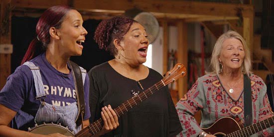 Rhiannon Giddens performing with her sister, singer Lalenja Harrington, and singer-songwriter Laurelyn Dossett. 