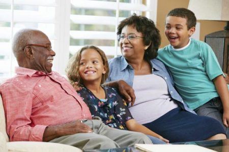 grandparents smiling with young children