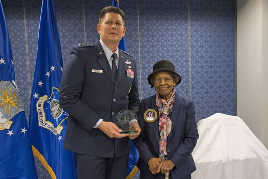 Dr. Gladys West receives an award from Commander Lt. Gen. DT Thompson. 