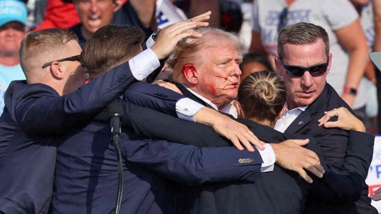 Donald Trump was rushed off stage with blood on his ear and face after the shooting.