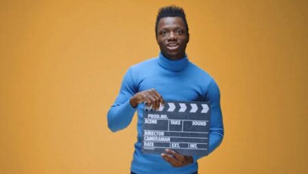 man with film clapboard