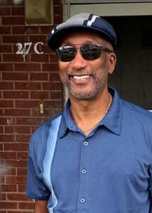 Randall Richardson in front of apartment 27C in the Hillcrest community.