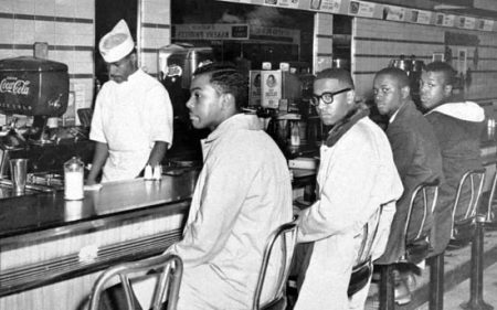 Joseph McNeil, Franklin McCain, Billy Smith, and Clarence Henderson during the 1960 sit-in at the Woolworth lunch counter in Greensboro, NC.