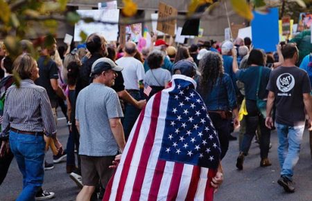 protestor wearing us flag