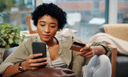 woman with cell phone and credit card full
