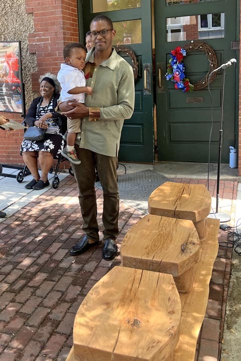 Kwadwo SomPimpong, the artisan of the YMI-Fia Bench, with his son. Photo: Urban News