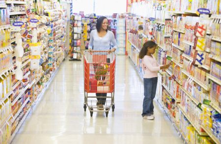 Mother and daughter shopping for groceries in supermarketv