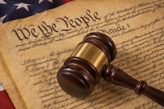 Judges gavel laying on top of the US Constitution